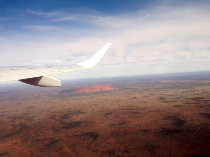 Uluru stands alone in a scorched land